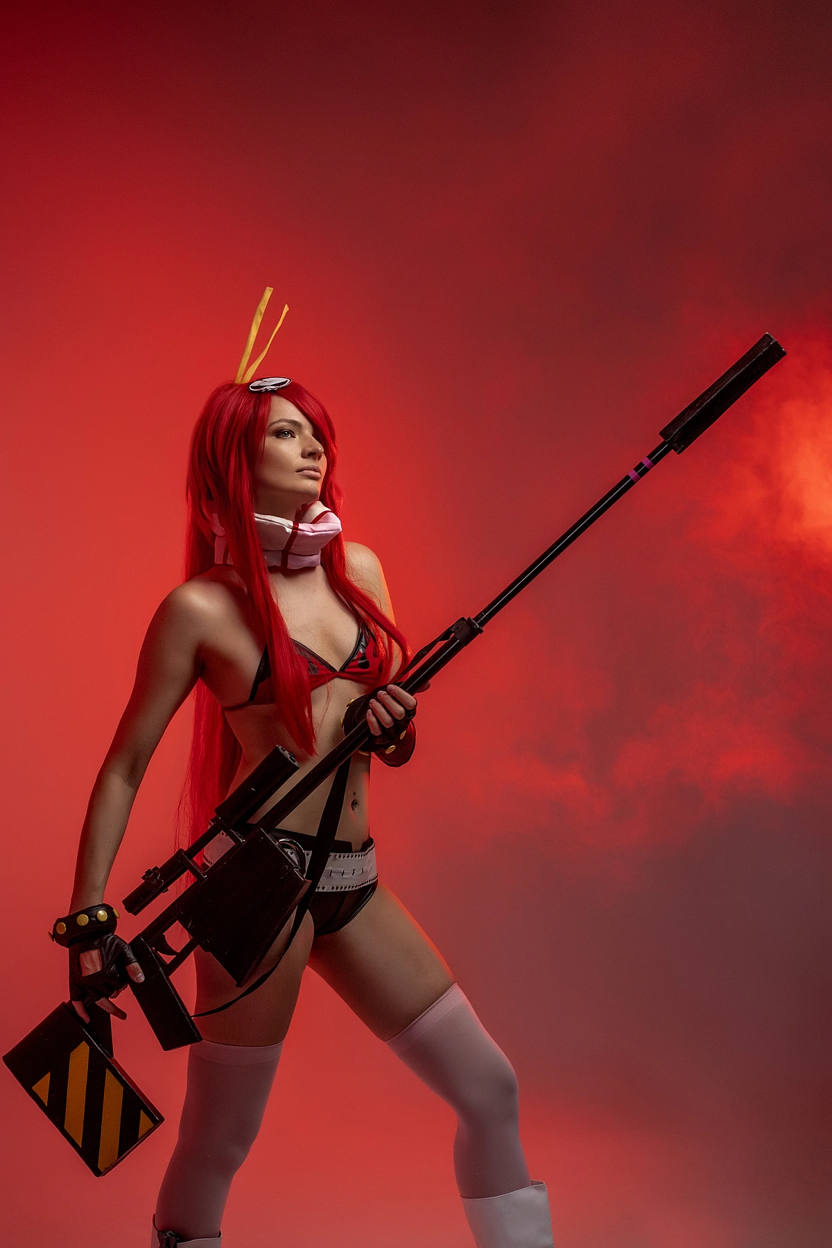 Cosplay bikini girl with rifle, red hair, thigh-highs, smoke background, red studio lighting, dynamic stance, weapon pose